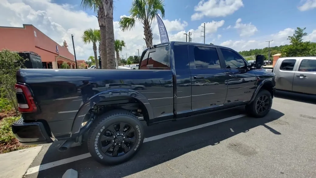 Black RAM 1500 side rear view with tinted windows
