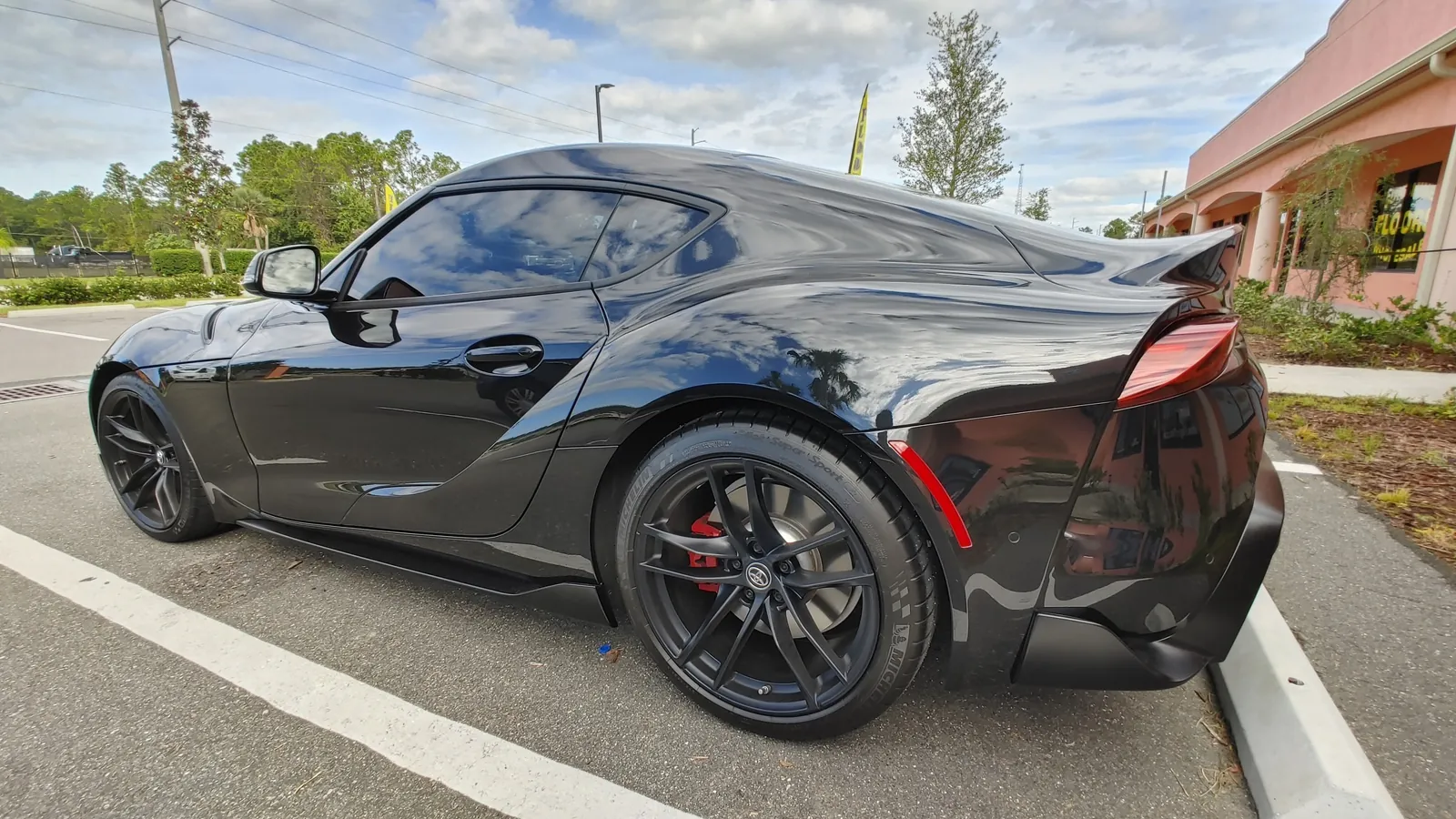 Black Toyota Supra rear three-quarter, tinted