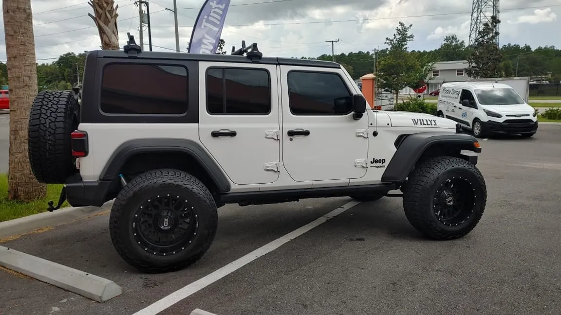 White Jeep Wrangler side rear with tint